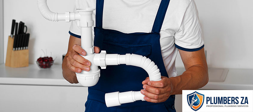 Plumber installing kitchen plumbing system for sink and water lines in Gauteng